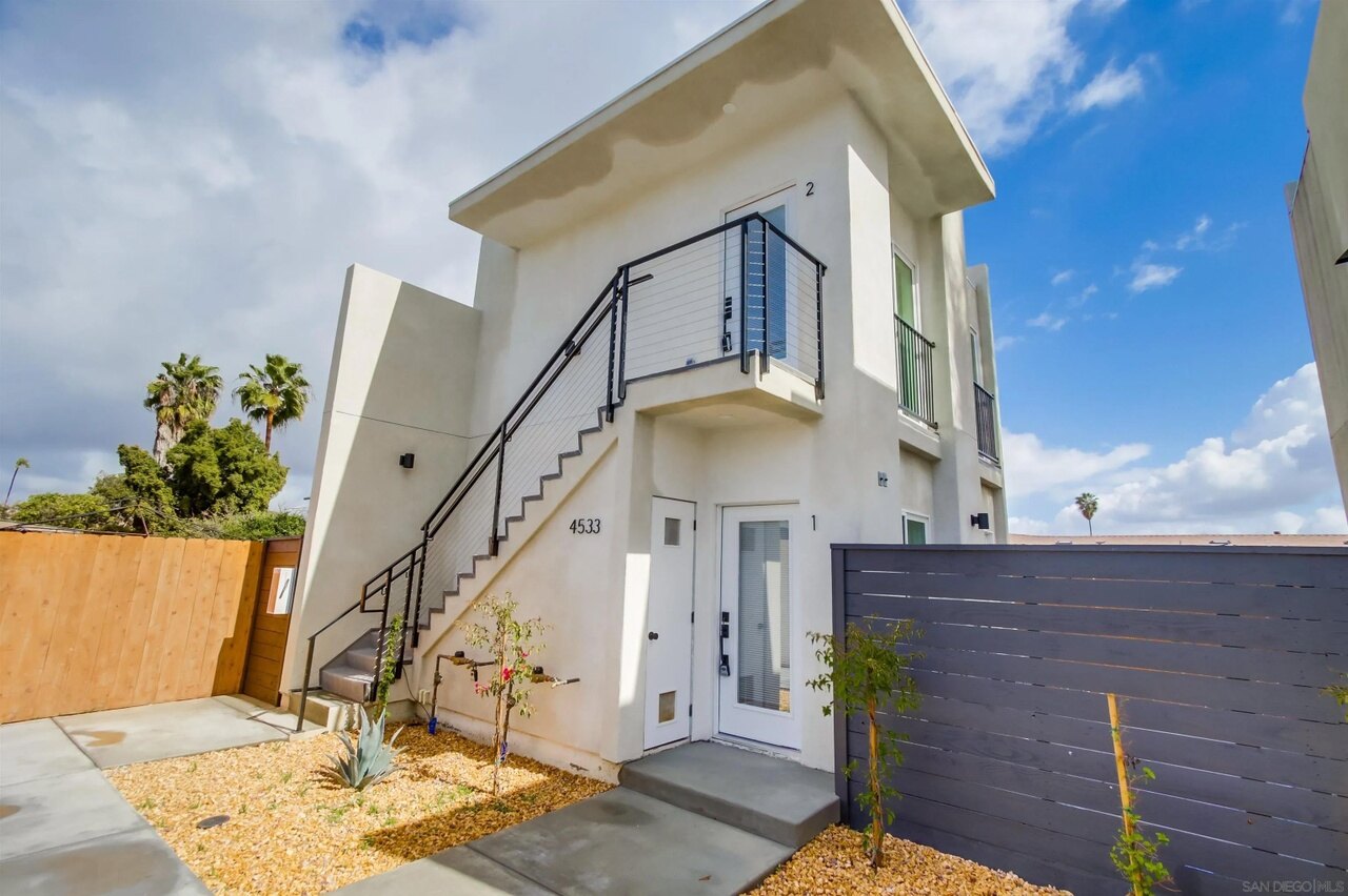 Two-story ADU exterior and private entries at the 63rd Street project