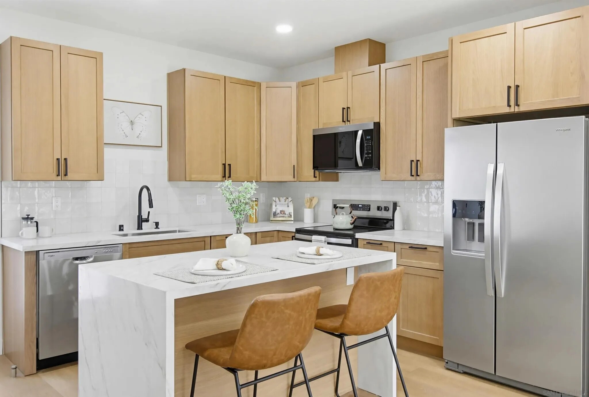 Wood cabinetry and marble-look island in a Felton Street kitchen
