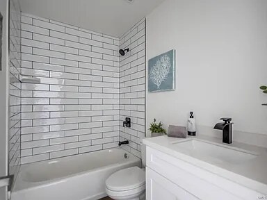 Finished bathroom with tiled tub surround at Utah Street